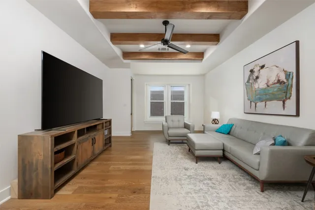 a spacious bedroom with a bed a couch and large window