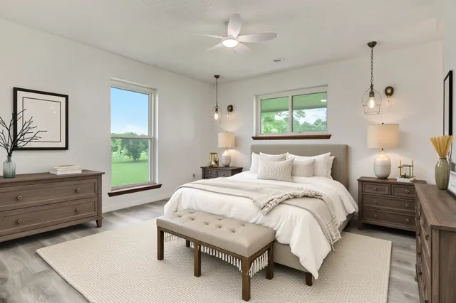 a spacious bedroom with a bed and a window