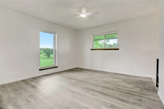 wooden floor in an empty room with a window