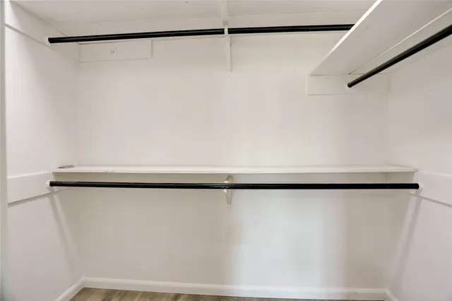 a bedroom with a bed and a potted plant