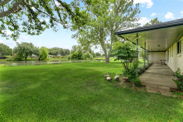 a view of a house with backyard sitting area and garden