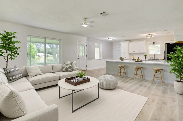 a living room with furniture and a large window