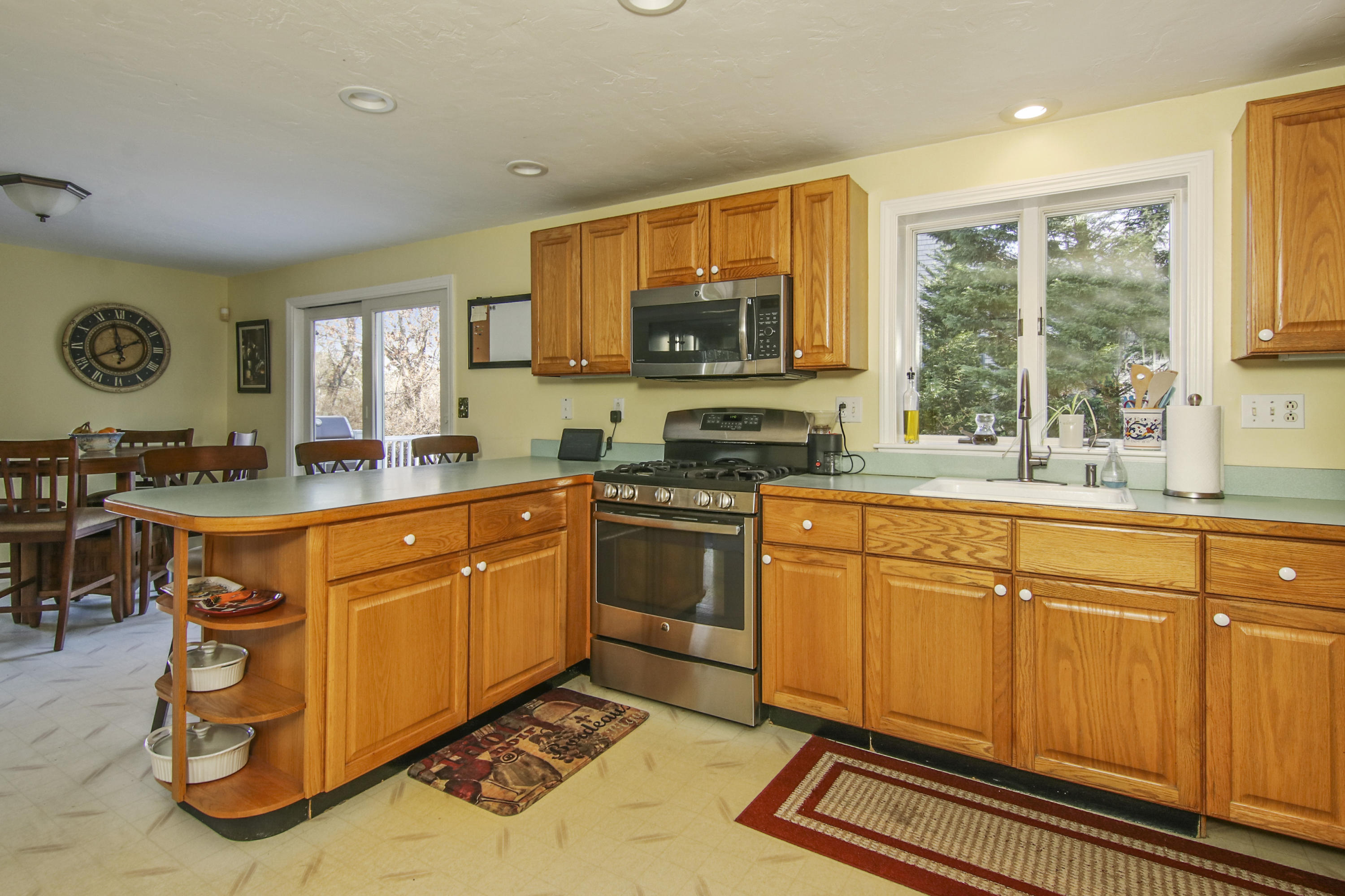 6 Hogan Drive Mashpee, MA 02649 - Photo 12 of 30 a kitchen with stainless steel appliances granite countertop a stove a sink and a microwave