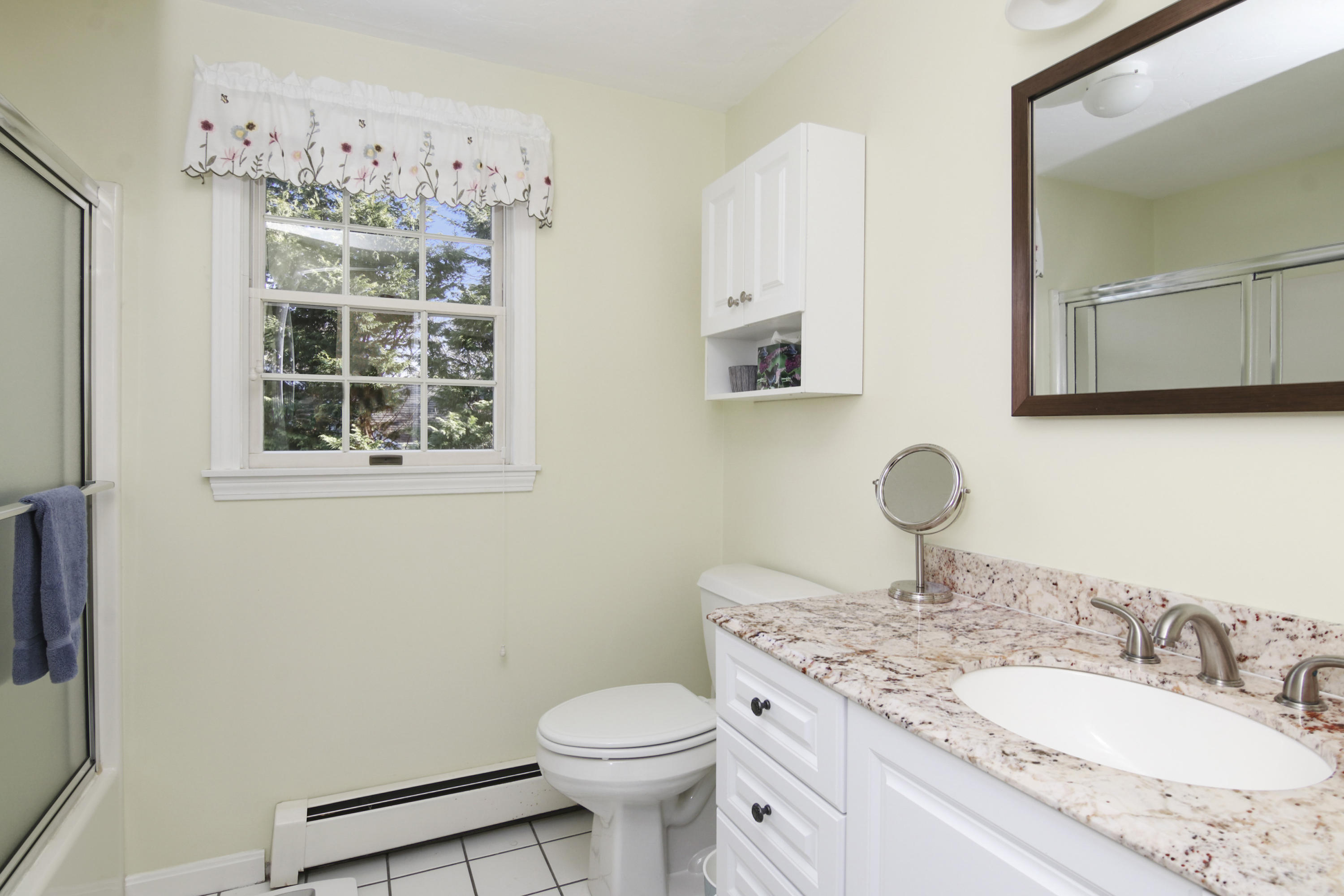 6 Hogan Drive Mashpee, MA 02649 - Photo 27 of 30 a bathroom with a granite countertop toilet a sink and a mirror
