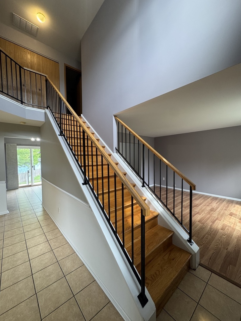 1716 William Drive Romeoville, IL 60446 - Photo 2 of 18 a view of staircase with white walls and a window