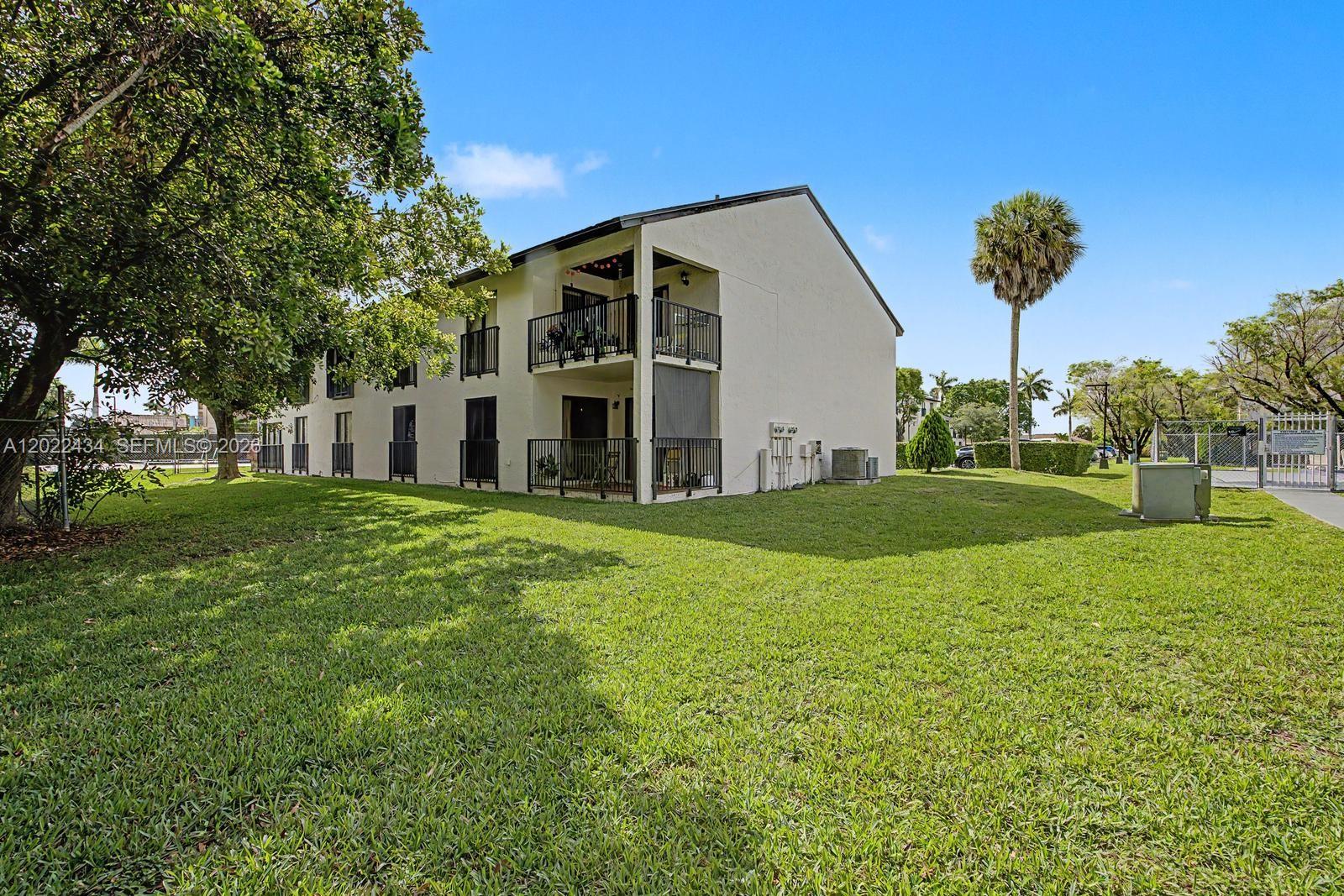 13045 Southwest 68th Street, Unit 111 Miami, FL 33183 - Photo 14 of 15 a view of a house with backyard and garden