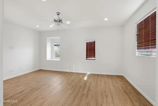 a view of hallway with wooden floor