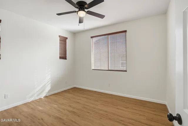 a patio with table and chairs and potted plants