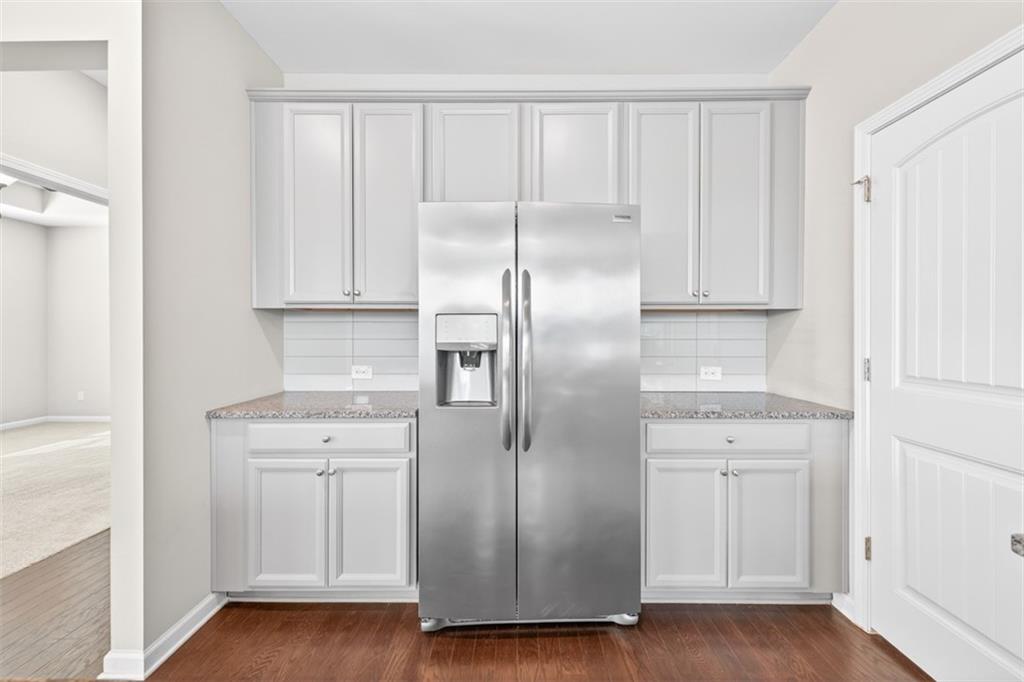 2405 Boxwalking Court Cumming, GA 30040 - Photo 14 of 54 a kitchen with a refrigerator a sink and cabinets