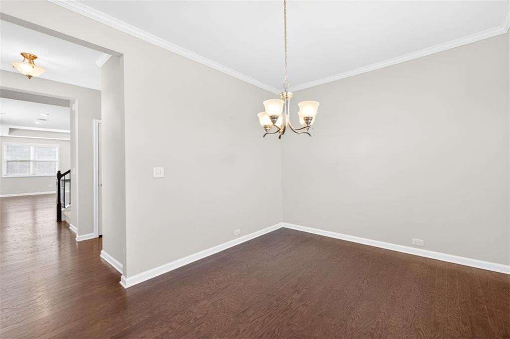 2405 Boxwalking Court Cumming, GA 30040 - Photo 16 of 54 a view of a chandelier with wooden floor and chandelier