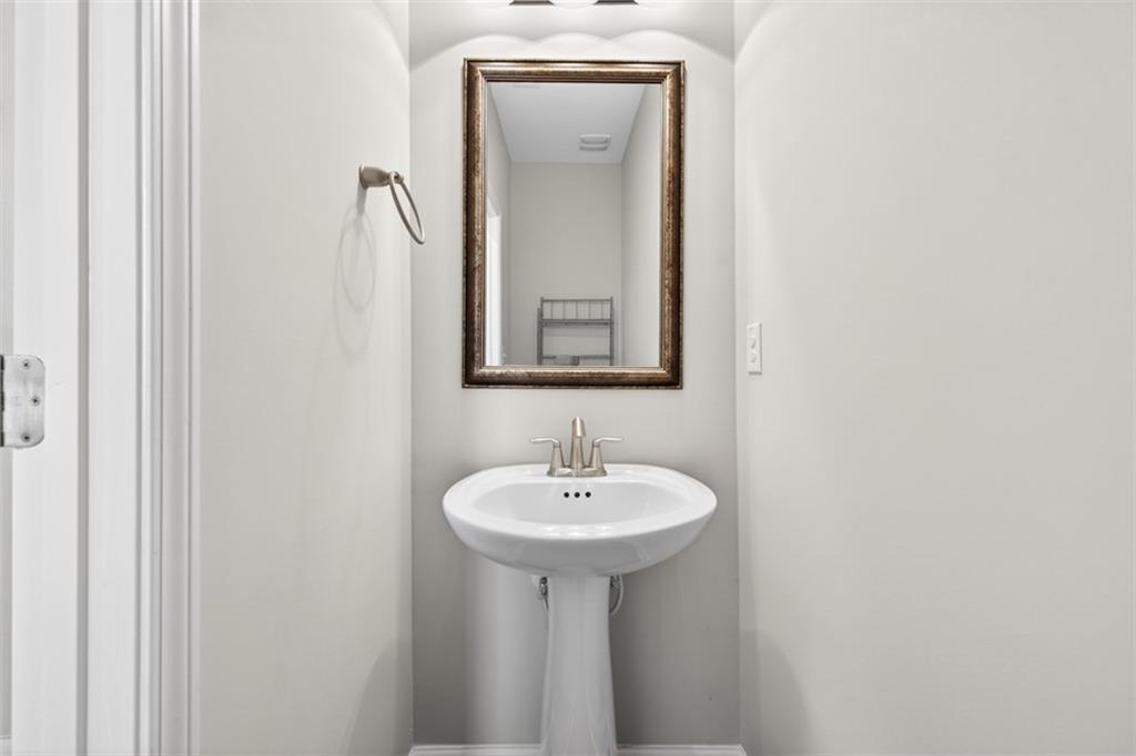 2405 Boxwalking Court Cumming, GA 30040 - Photo 17 of 54 a bathroom with a sink and a mirror