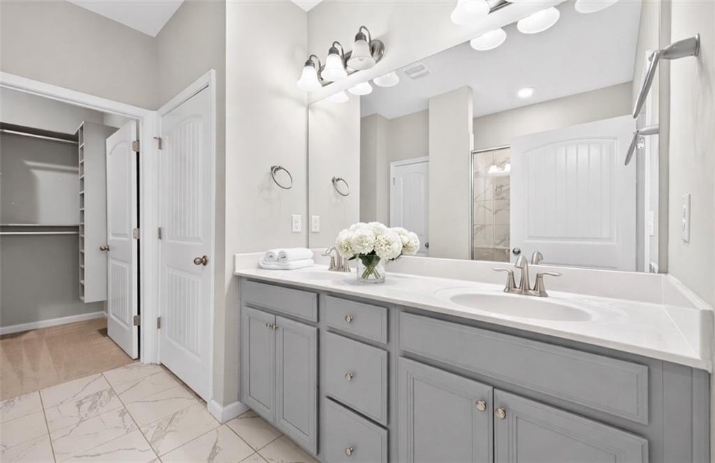 2405 Boxwalking Court Cumming, GA 30040 - Photo 24 of 54 a bathroom with a double vanity sink mirror and double