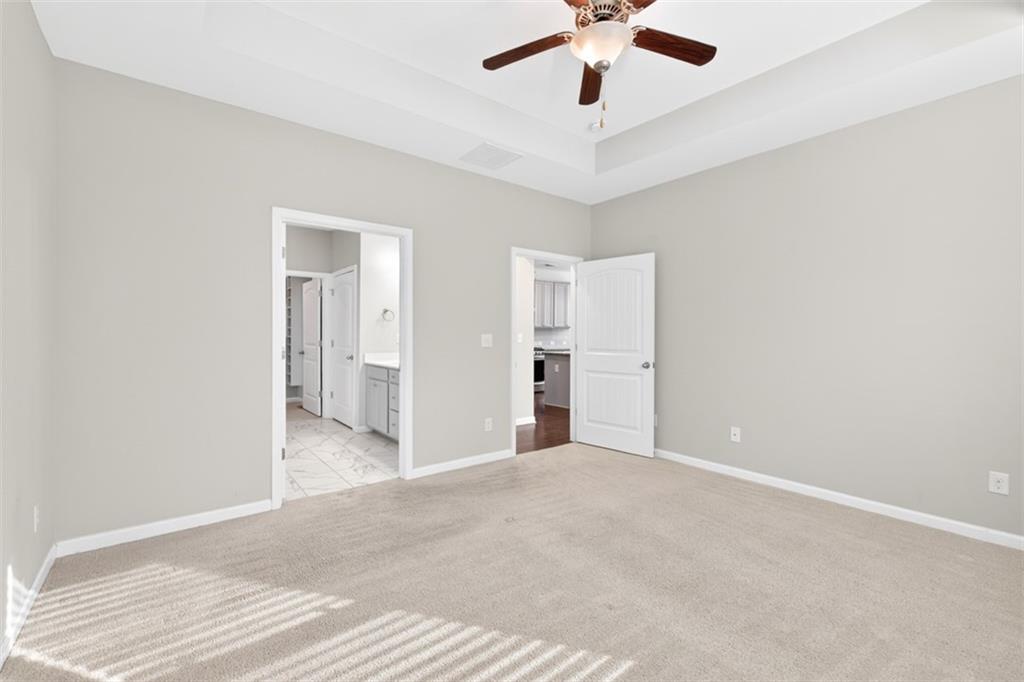 2405 Boxwalking Court Cumming, GA 30040 - Photo 25 of 54 an empty room with fan and entrance