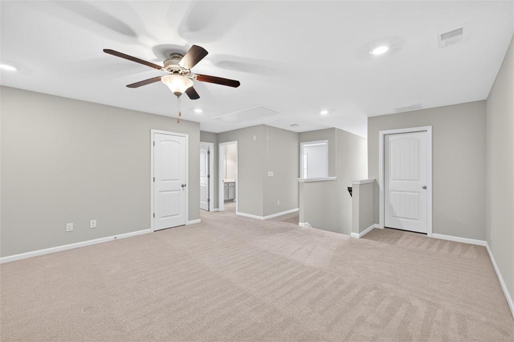 2405 Boxwalking Court Cumming, GA 30040 - Photo 29 of 54 a view of an empty room with a ceiling fan