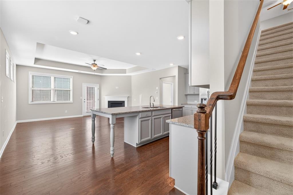 2405 Boxwalking Court Cumming, GA 30040 - Photo 3 of 54 a view of a kitchen with furniture and wooden floor