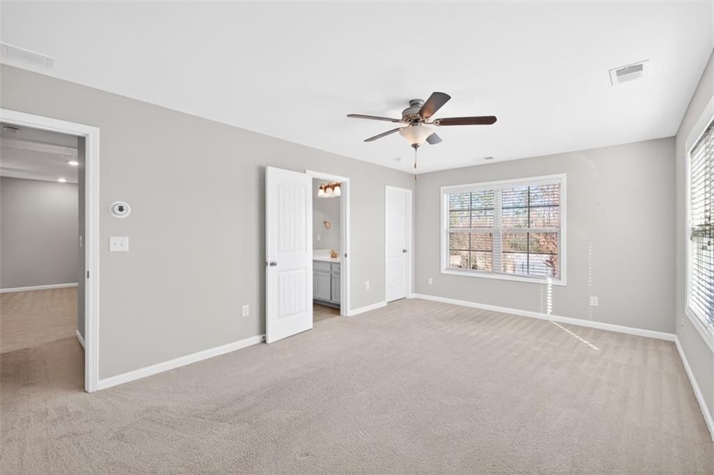 2405 Boxwalking Court Cumming, GA 30040 - Photo 38 of 54 a view of a big room with windows and chandelier fan