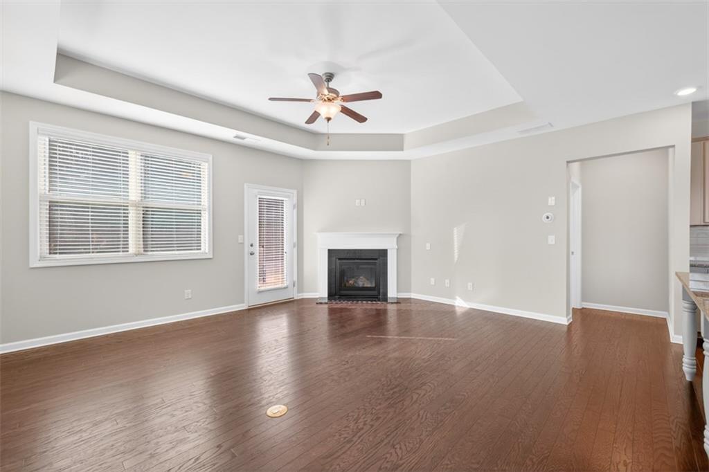 2405 Boxwalking Court Cumming, GA 30040 - Photo 4 of 54 a view of an empty room with wooden floor fireplace and a window