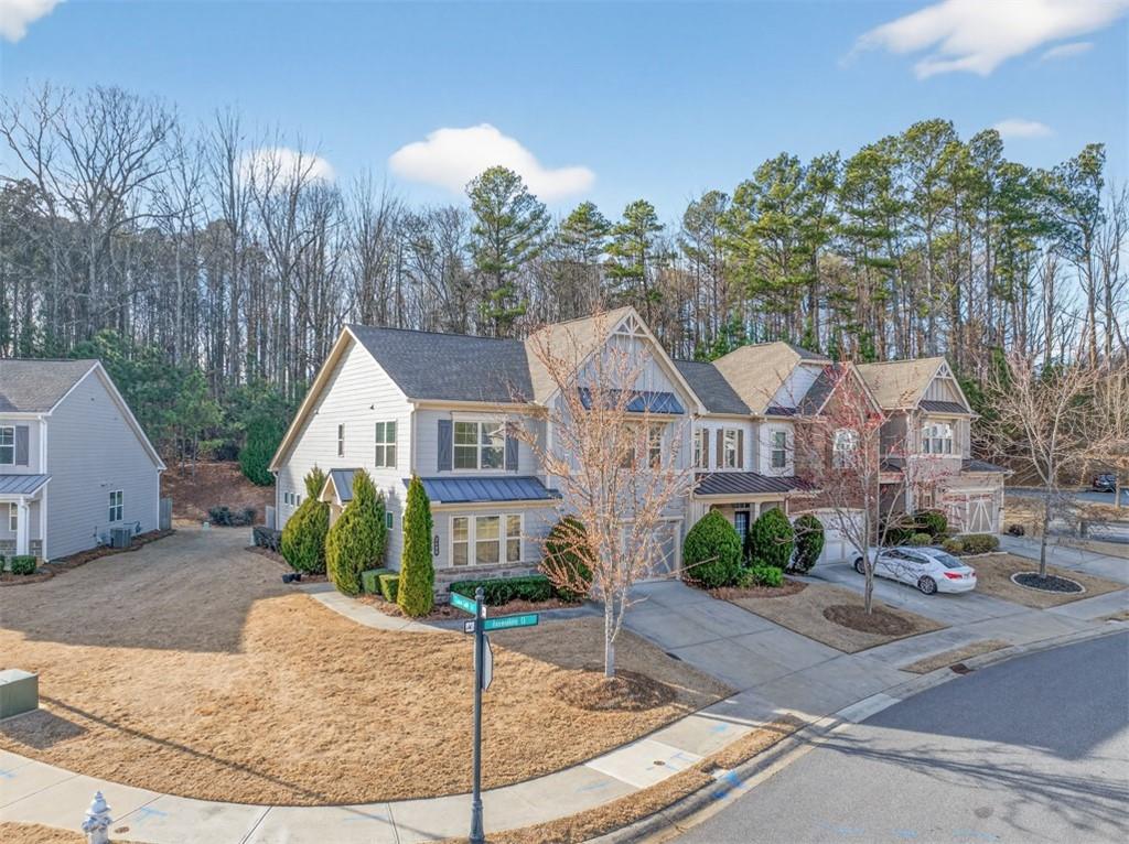 2405 Boxwalking Court Cumming, GA 30040 - Photo 45 of 54 a front view of a house with a yard and potted plants
