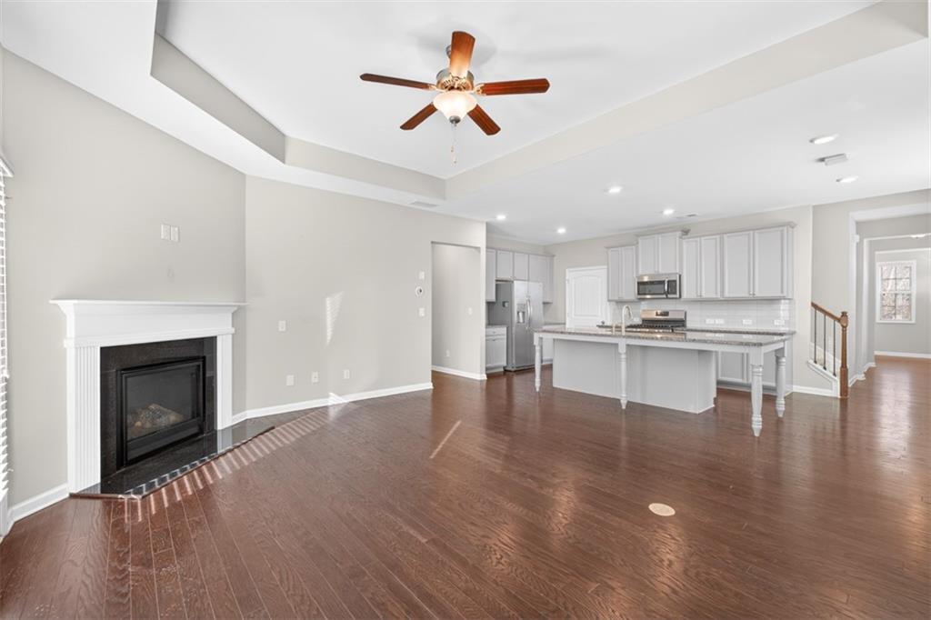 2405 Boxwalking Court Cumming, GA 30040 - Photo 6 of 54 a view of kitchen with refrigerator stove and a fireplace