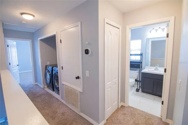 a view of a bathroom from a hallway