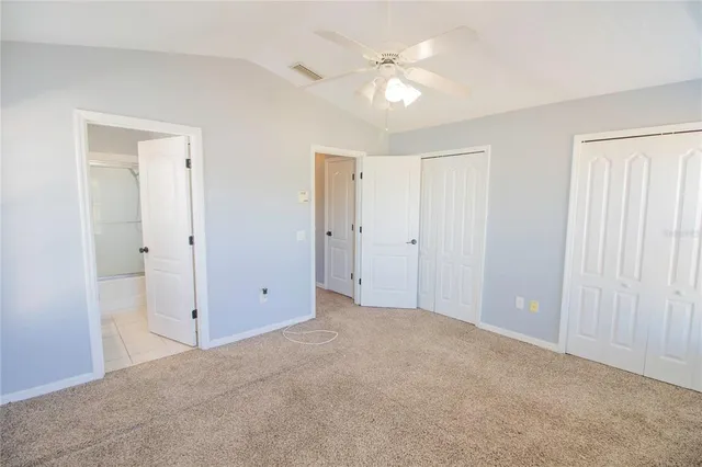 a view of an empty room with a ceiling fan