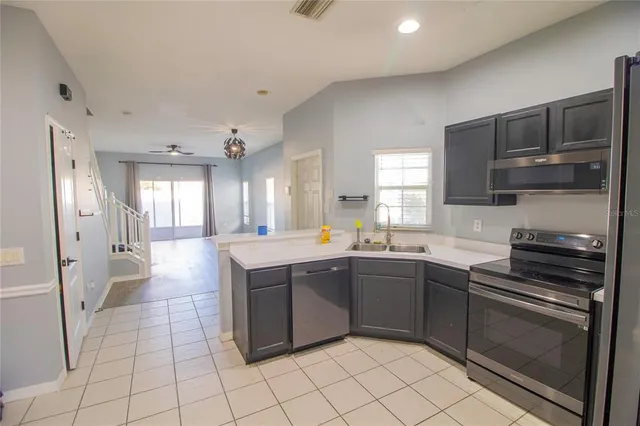 a kitchen with stainless steel appliances granite countertop a sink and cabinets