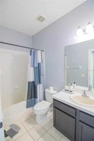 a bathroom with a sink a toilet a mirror and shower