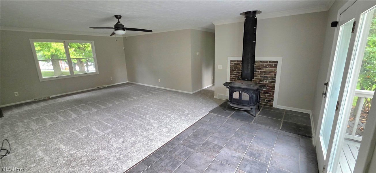 252 Saxe Road Mogadore, OH 44260 - Photo 9 of 24 Spacious room featuring light-toned walls, a ceiling fan, and large windows