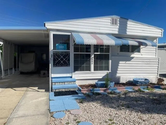 a front view of a house with a large window and yard