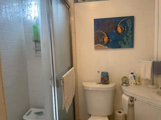 a bathroom with a sink and mirror with toilet