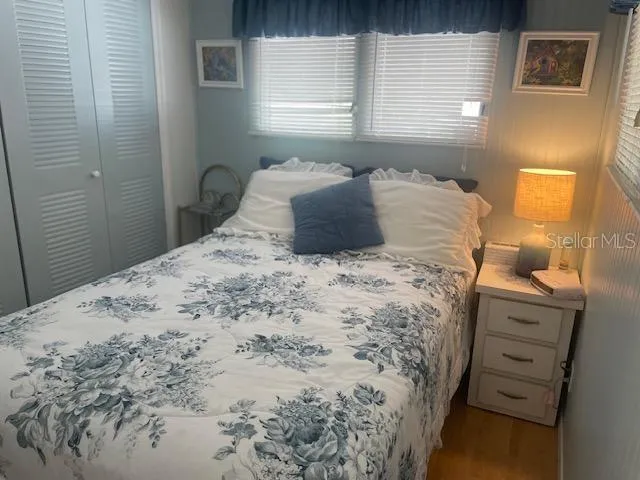 a bedroom with a bed and a window