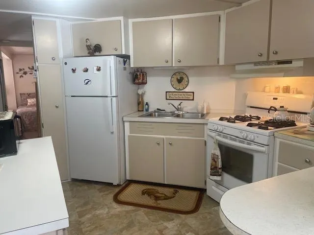 a kitchen with a stove and a refrigerator