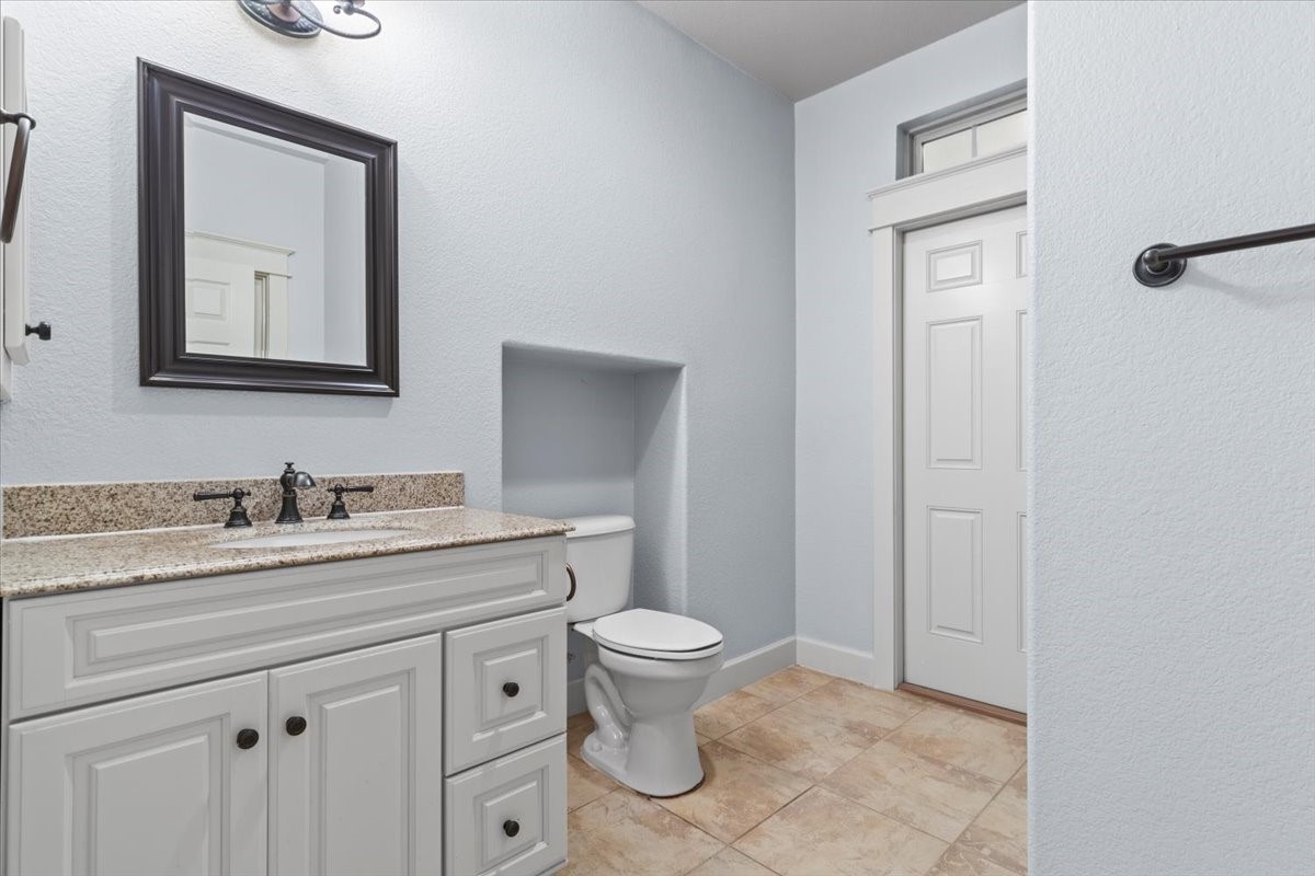 28822 Village Bend Magnolia, TX 77355 - Photo 27 of 45 a bathroom with a granite countertop sink vanity mirror and toilet