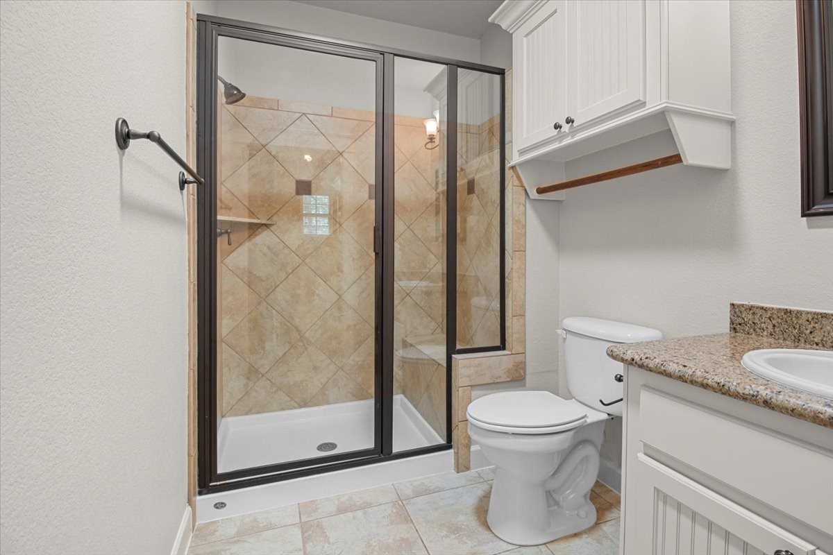 28822 Village Bend Magnolia, TX 77355 - Photo 29 of 45 a bathroom with a granite countertop sink toilet and shower