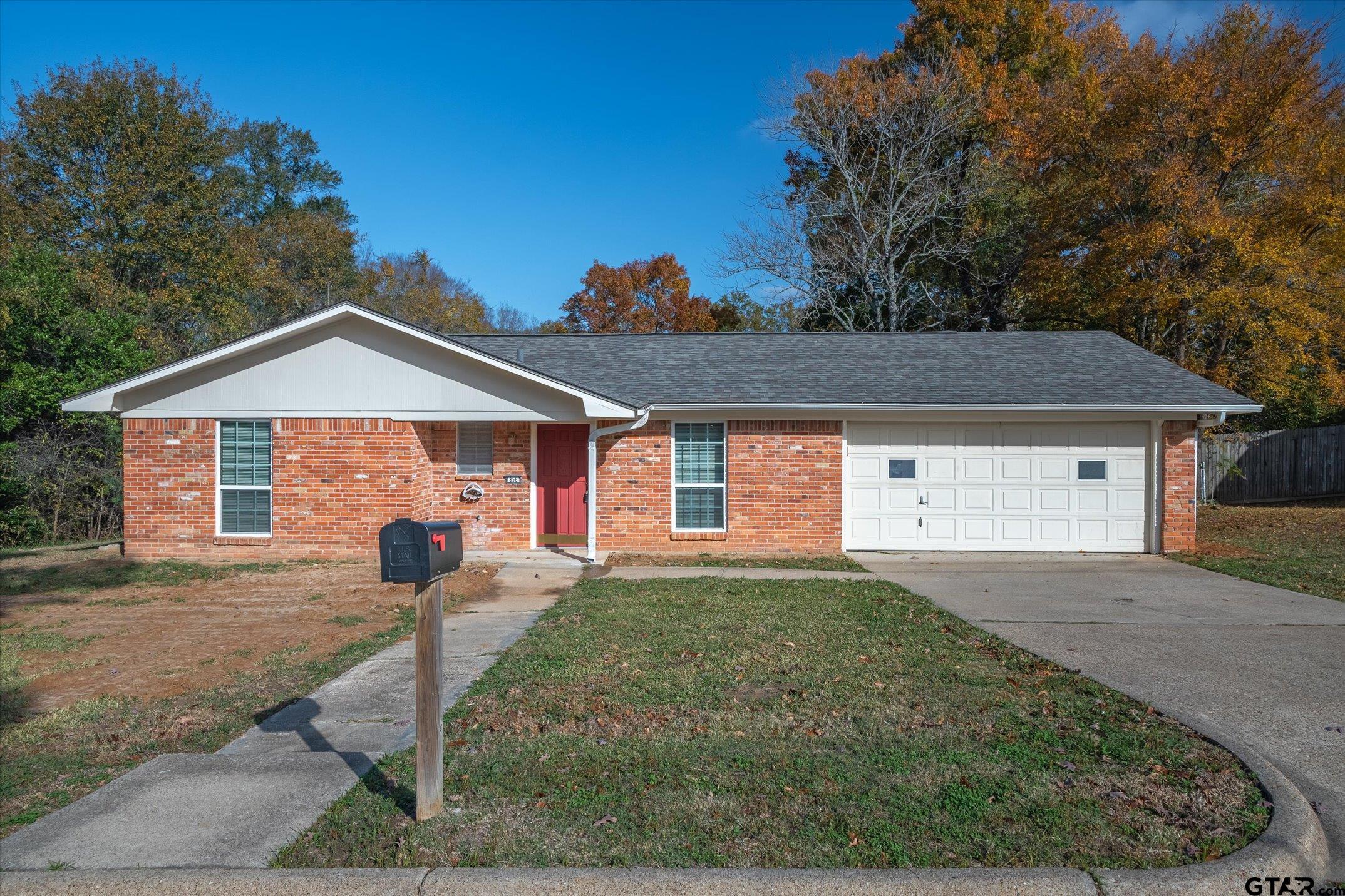 856 Ave A Canton, TX 75103 - Photo 1 of 40 a front view of a house with a yard and garage