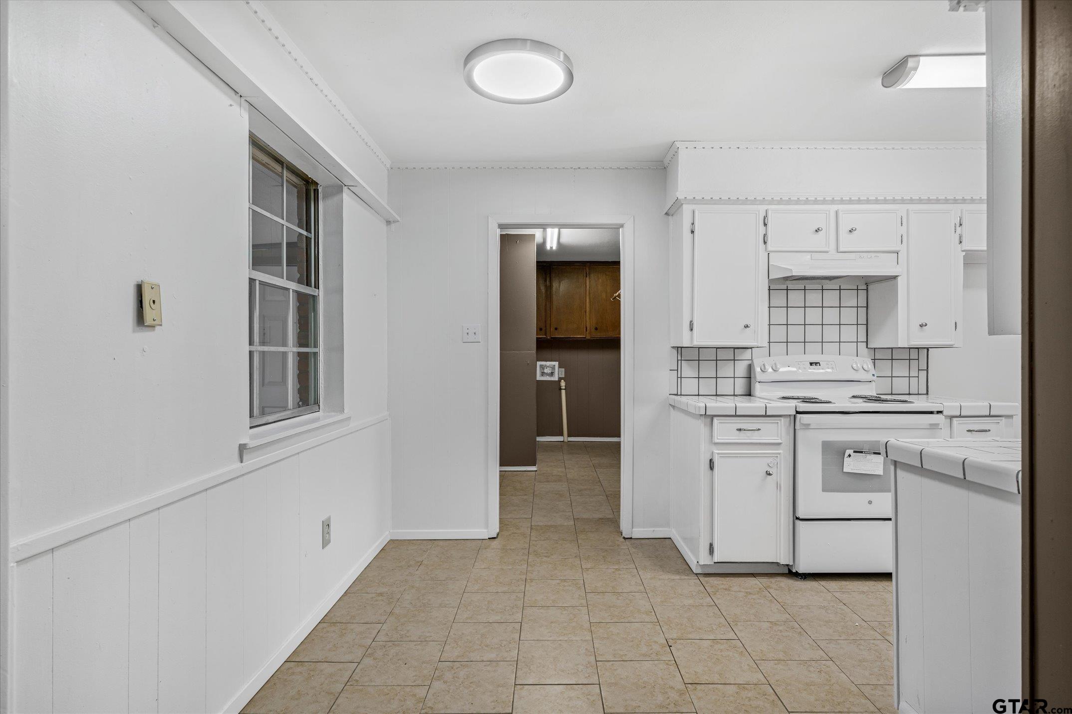 856 Ave A Canton, TX 75103 - Photo 21 of 40 a kitchen with white cabinets and white appliances