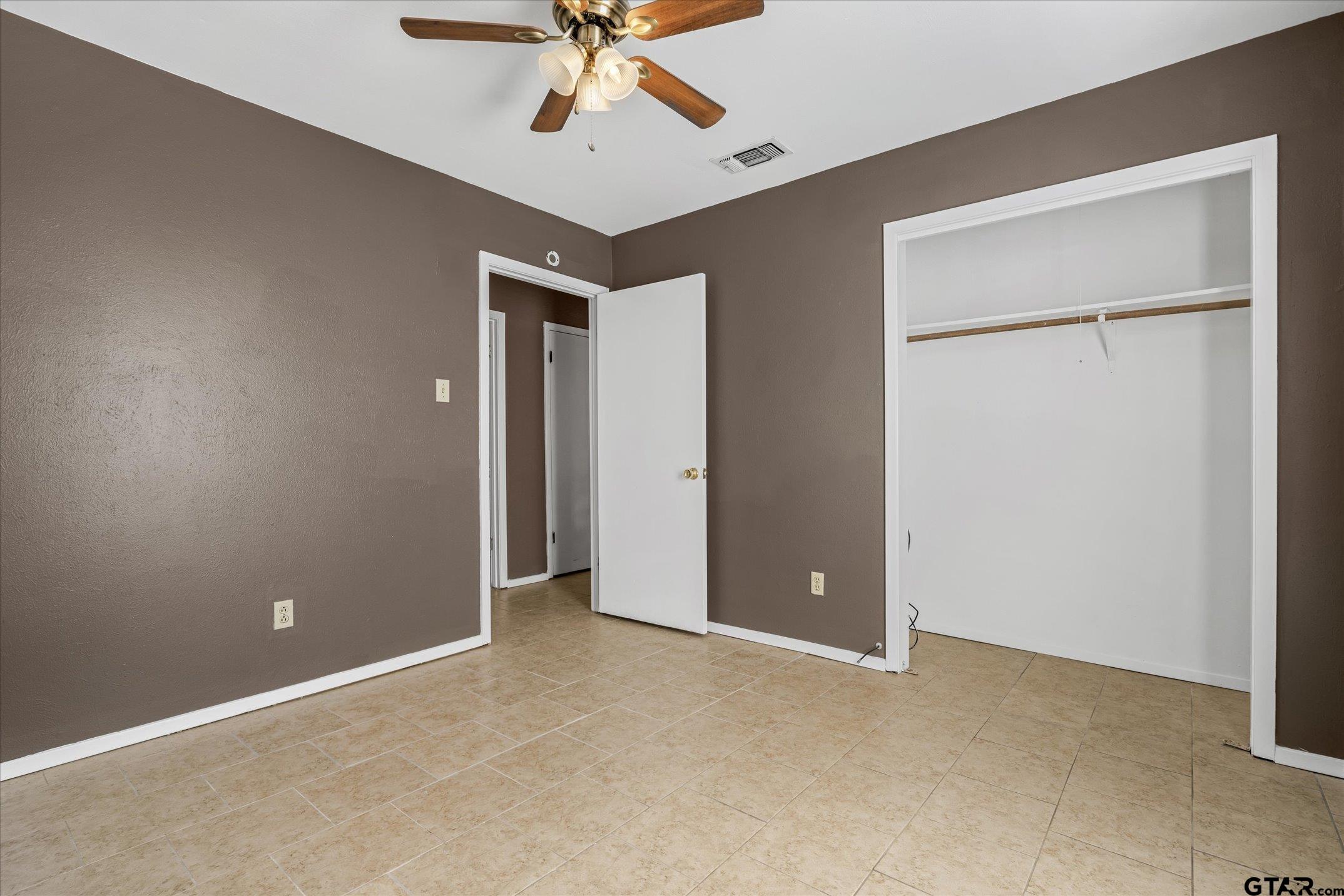 856 Ave A Canton, TX 75103 - Photo 33 of 40 an empty room with closet and a chandelier fan