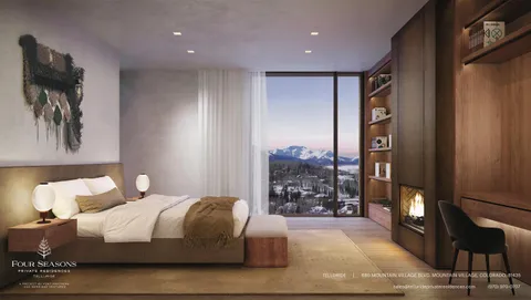 a bedroom with a large bed and a painting on the wall