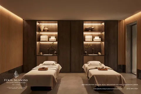 a bedroom with two beds and a lamp