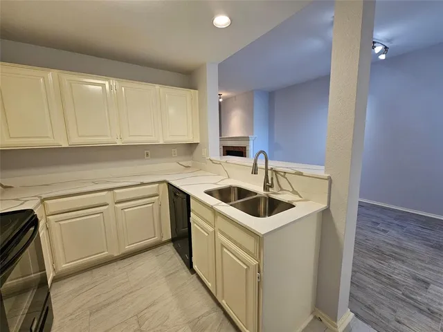 a kitchen with a sink and cabinets