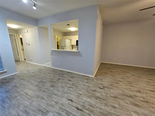 a view of livingroom with wooden floor and mirror