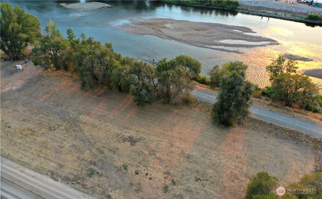 0 Asotin Street South Omak, WA 98841 - Photo 14 of 18 a view of a yard with plants and a bench