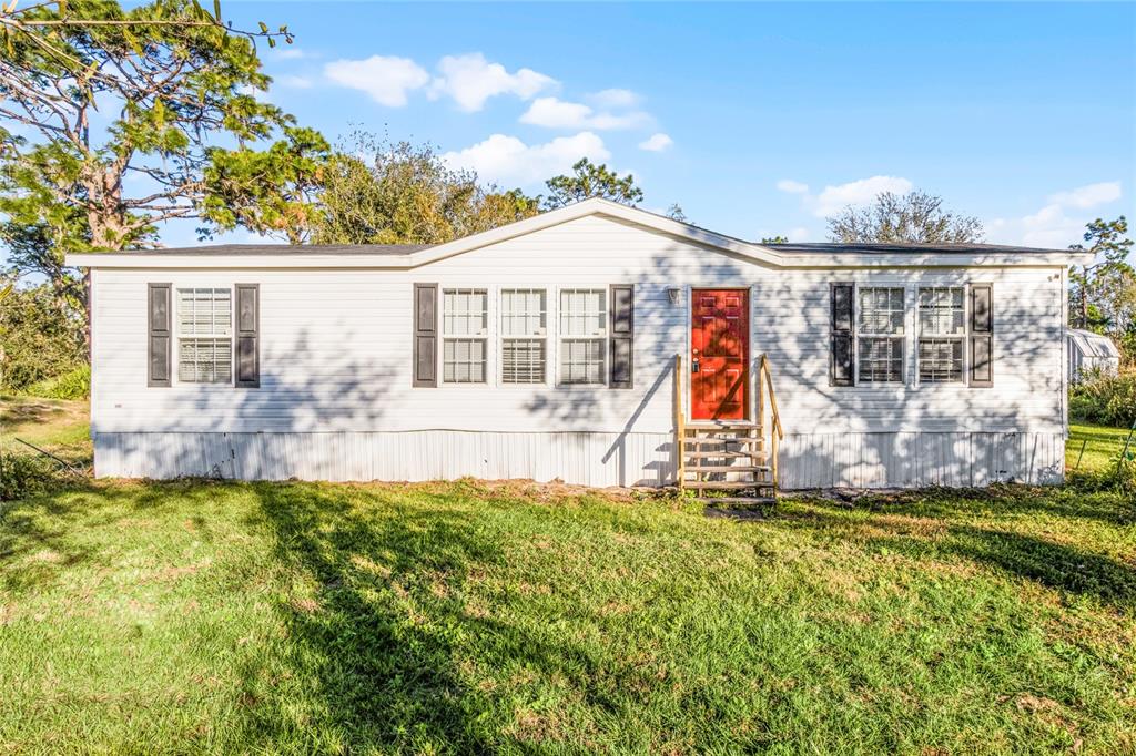 1408 McClellan Road Frostproof, FL 33843 - Photo 1 of 1 a view of a house with a yard