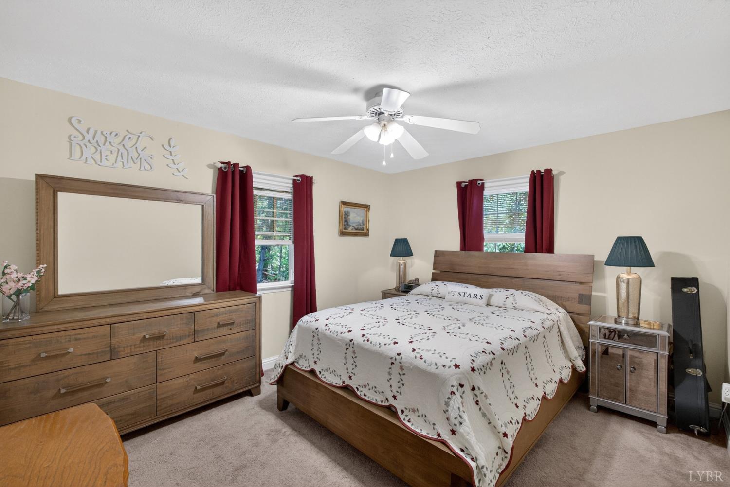 185 Clearview Circle Rustburg, VA 24588 - Photo 23 of 43 a bedroom with a large bed and a flat tv screen on dresser