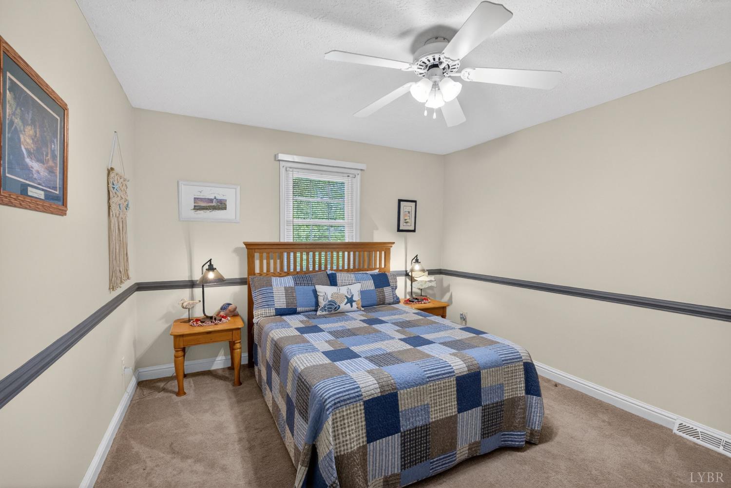 185 Clearview Circle Rustburg, VA 24588 - Photo 25 of 43 a bedroom with a bed a window and a chandelier