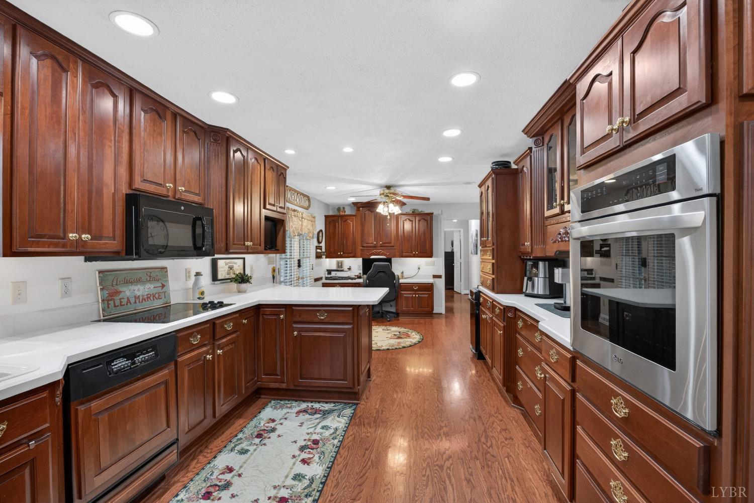 185 Clearview Circle Rustburg, VA 24588 - Photo 3 of 43 a large kitchen with stainless steel appliances wooden cabinets and a stove top oven