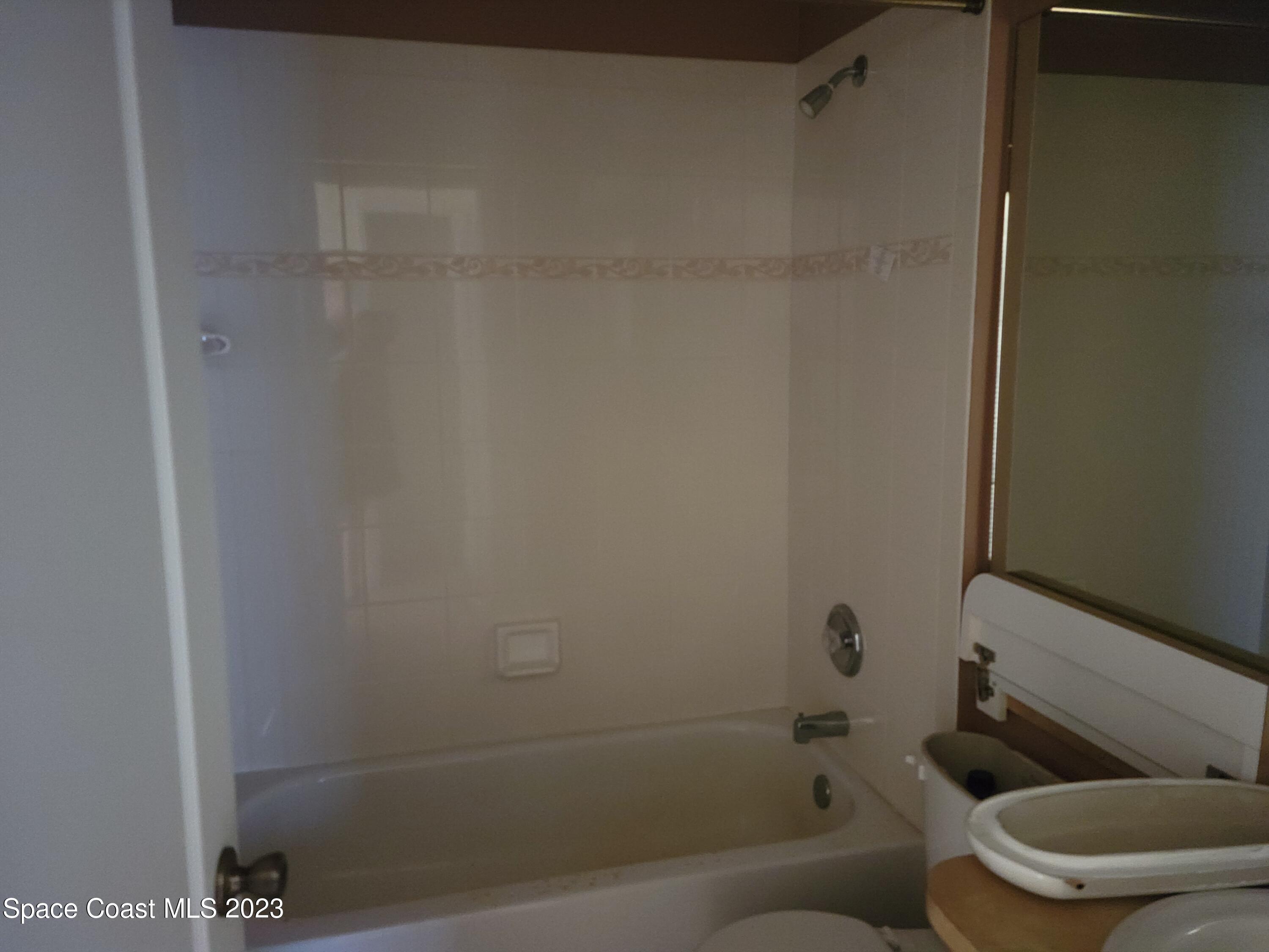 2219 Spring Creek Circle Palm Bay, FL 32905 - Photo 11 of 13 a bathroom with a toilet and a bathtub