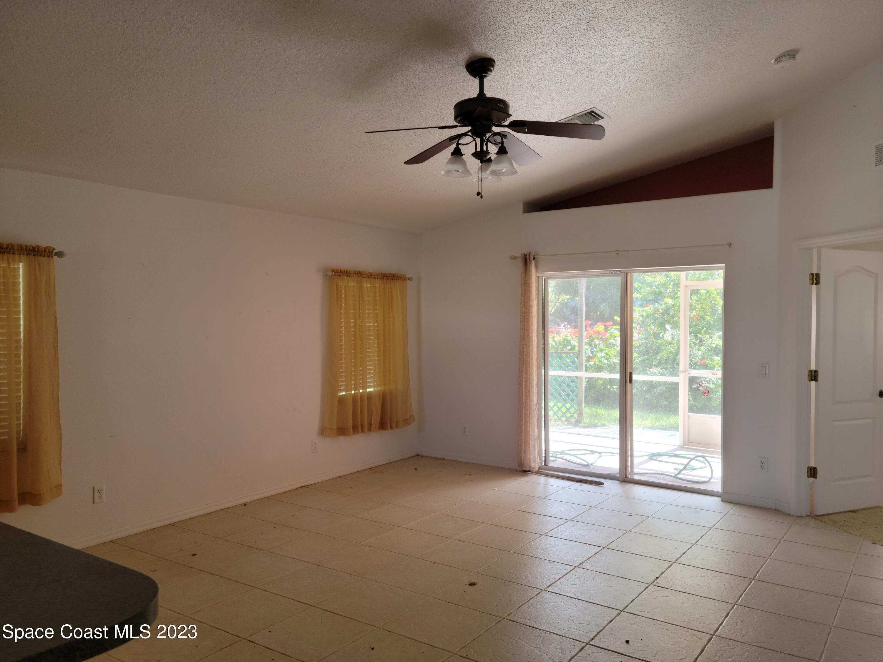 2219 Spring Creek Circle Palm Bay, FL 32905 - Photo 4 of 13 a view of an empty room with a window