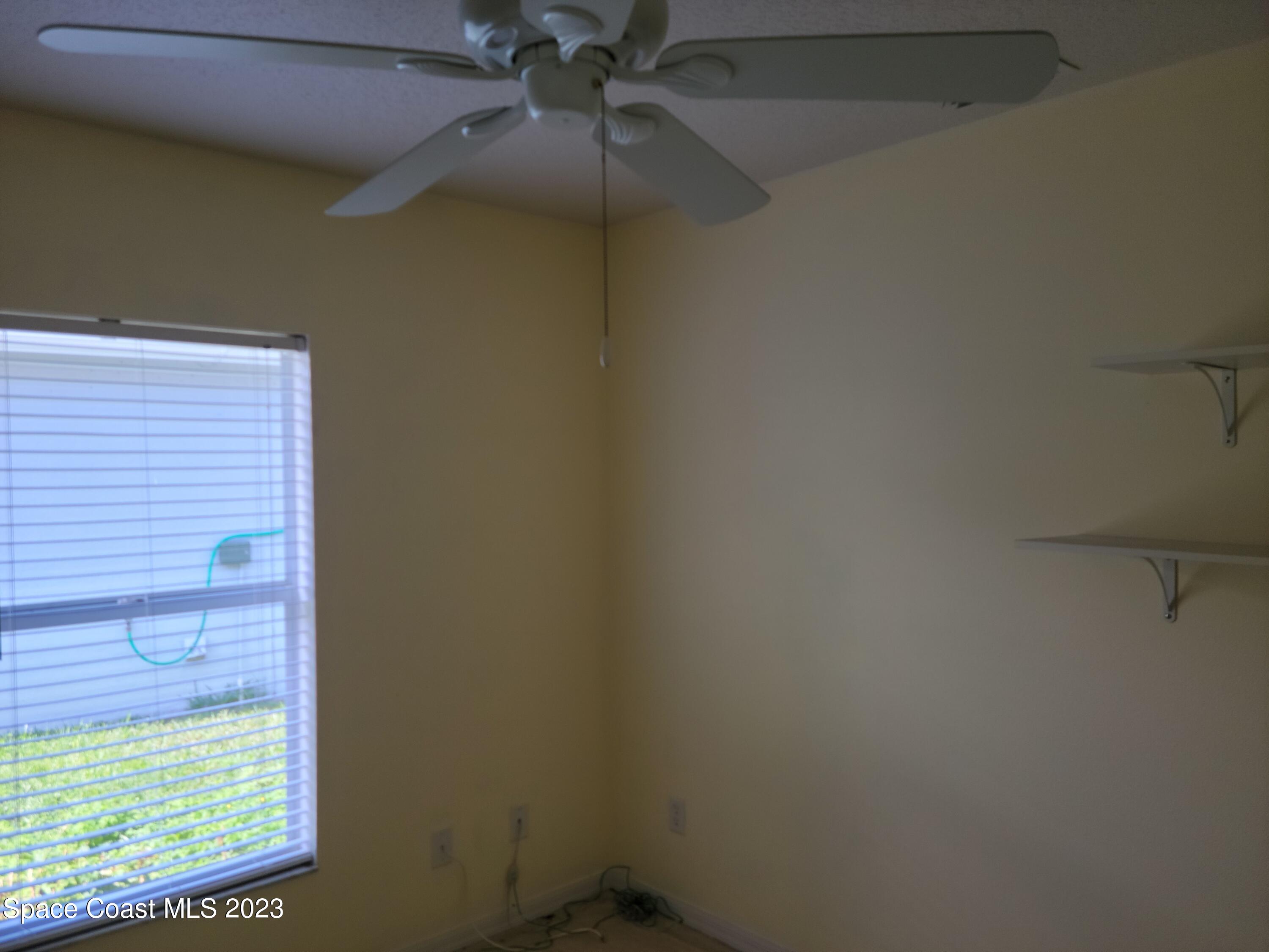 2219 Spring Creek Circle Palm Bay, FL 32905 - Photo 10 of 13 a small space with a window and a fan