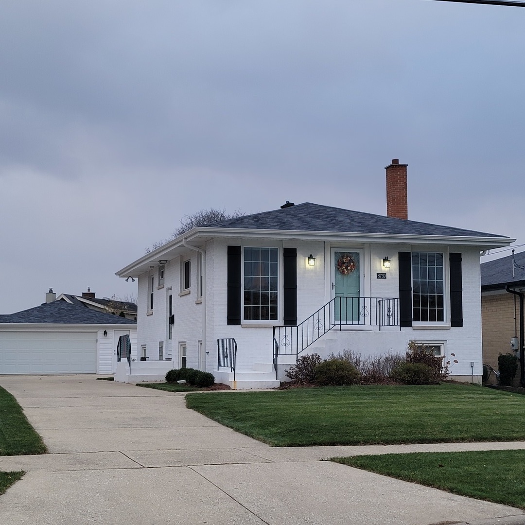 a front view of a house with a garden